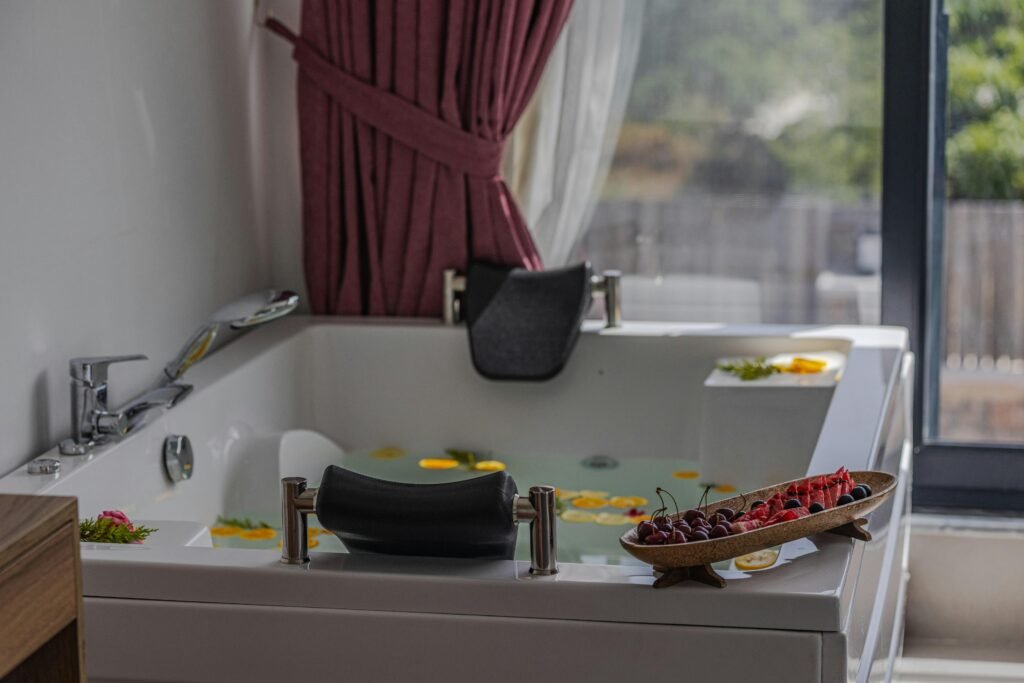 Relaxing indoor bath scene with fruits and petals, perfect for spa or luxury home vibes.